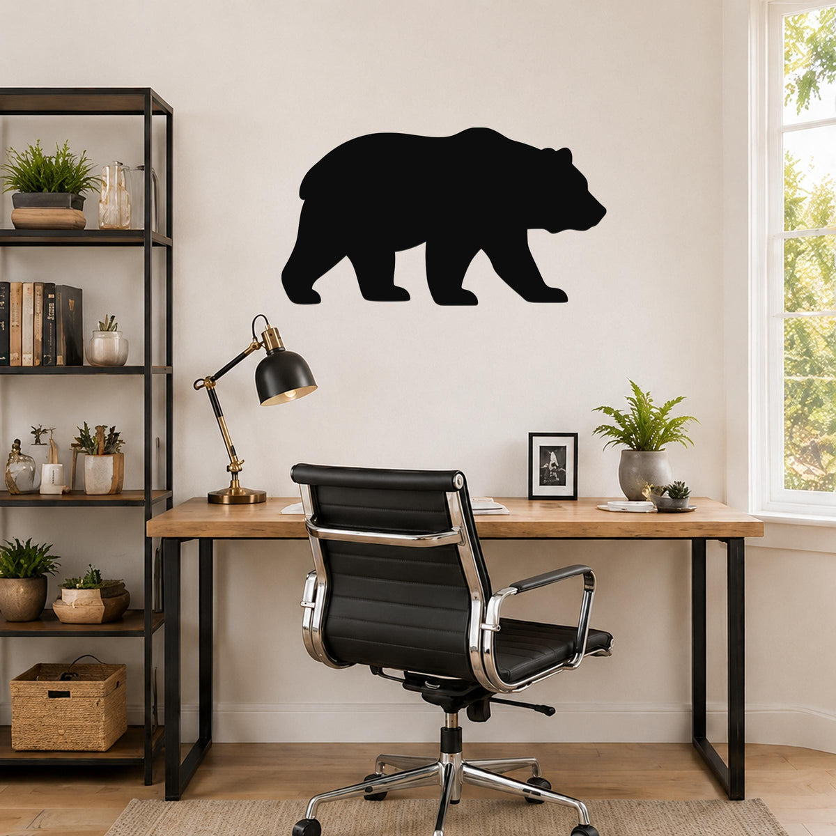 Black metal bear silhouette wall art mounted above a wooden desk in a home office.