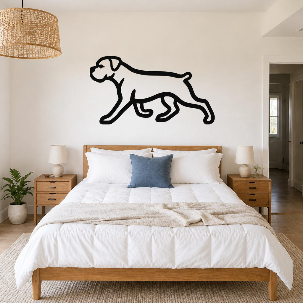 Black metal Boxer dog silhouette wall art mounted above a bed in a bedroom with wooden furniture and a woven pendant light.