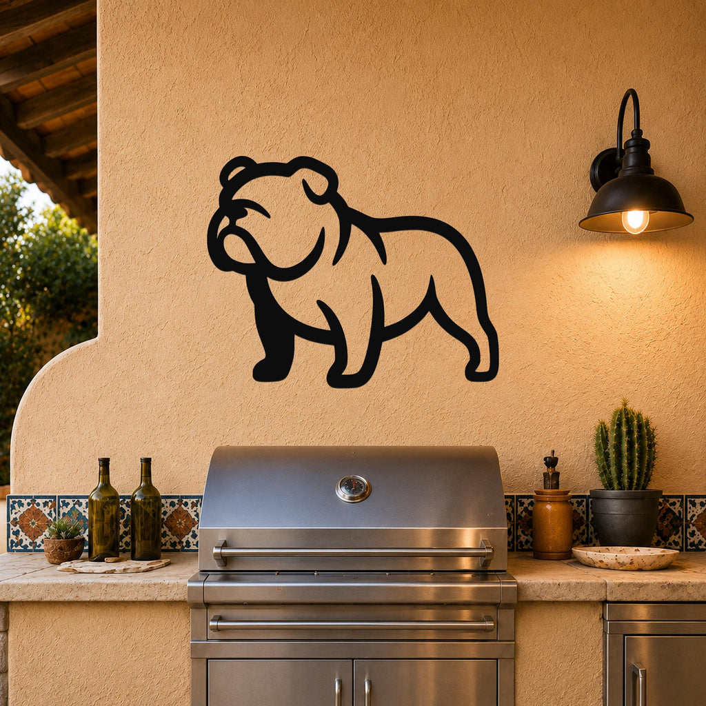 Black metal bulldog wall art silhouette mounted on a stucco wall above a stainless steel grill on an outdoor patio.