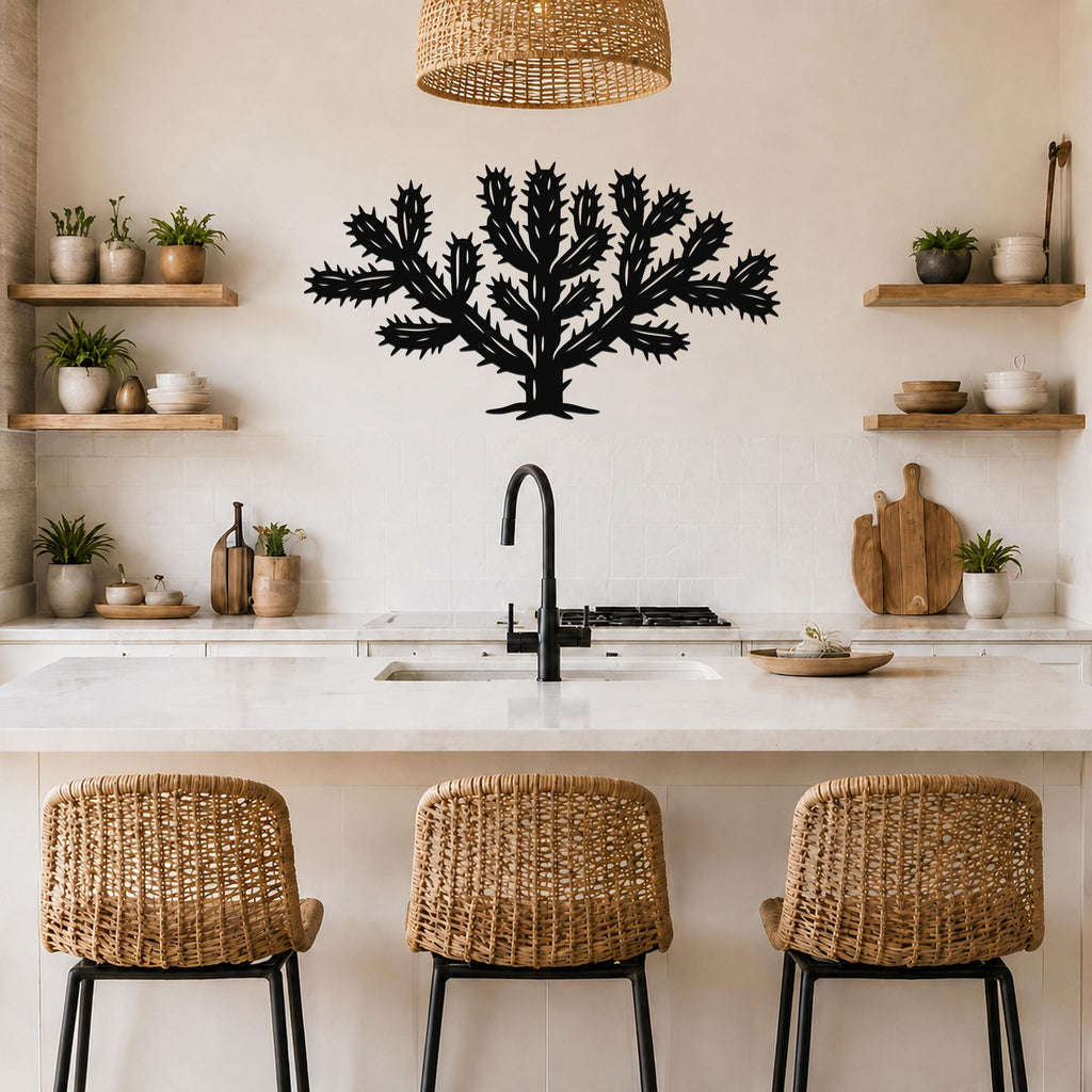 Black metal Cholla cactus wall art with spiky branch cutouts, mounted on a kitchen wall above a counter.