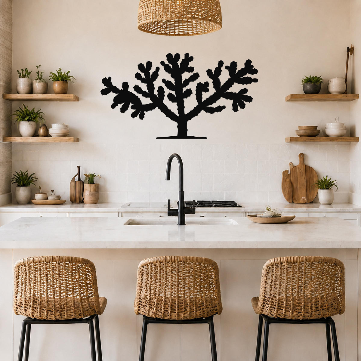 Black metal Cholla cactus wall art silhouette with branching cutouts, mounted on a kitchen wall above a counter.