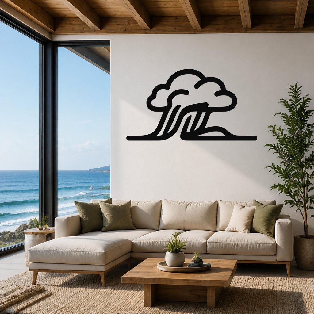 Black metal cloud and wave wall art silhouette mounted above a beige sectional sofa in a living room with ocean views.