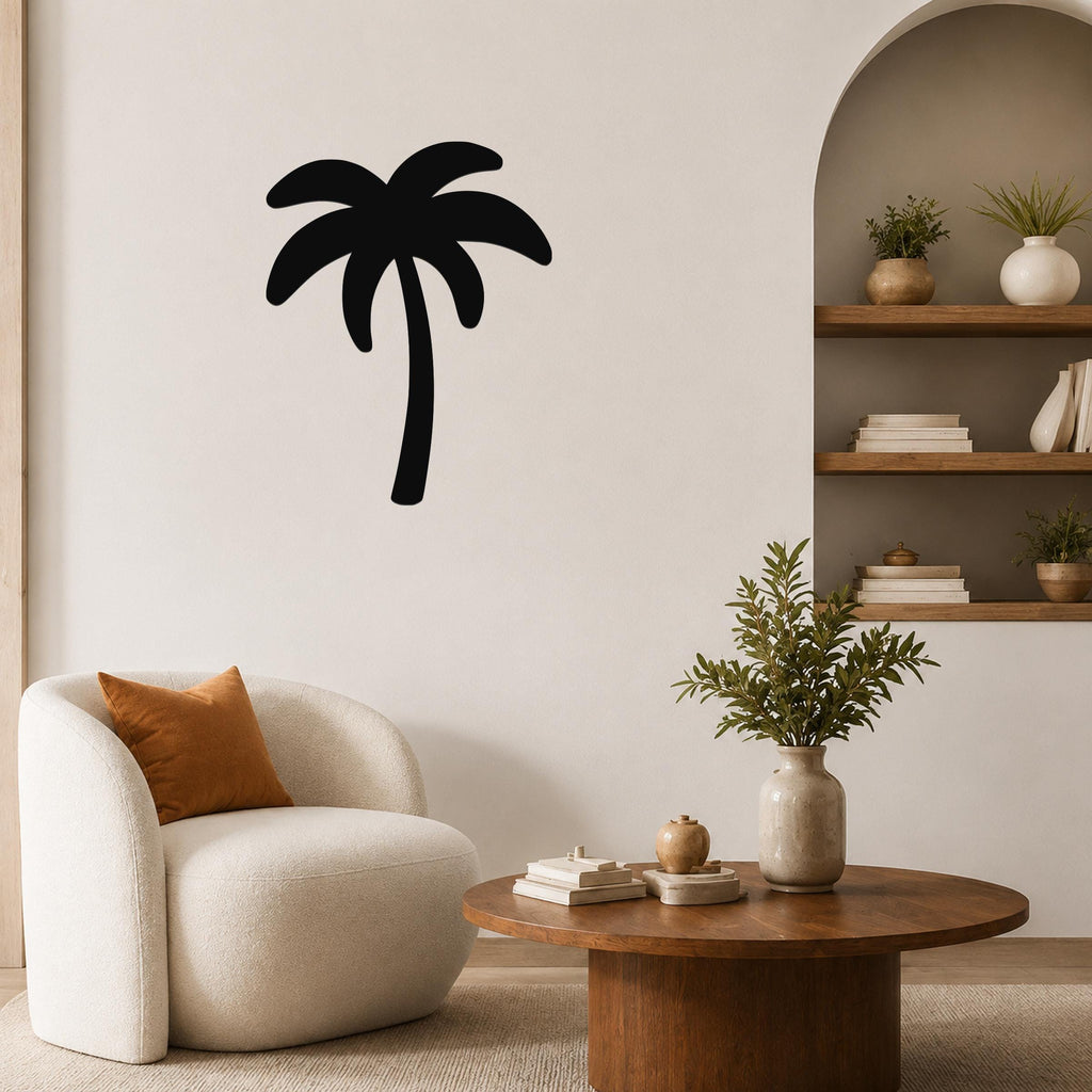 Black metal palm tree wall art silhouette mounted on a living room wall above a white armchair.