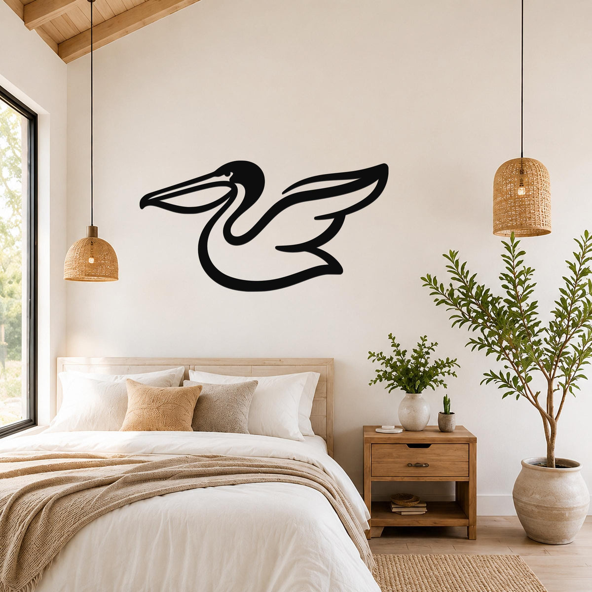 Black metal pelican wall art with a silhouette design, mounted on a bedroom wall above a bed.
