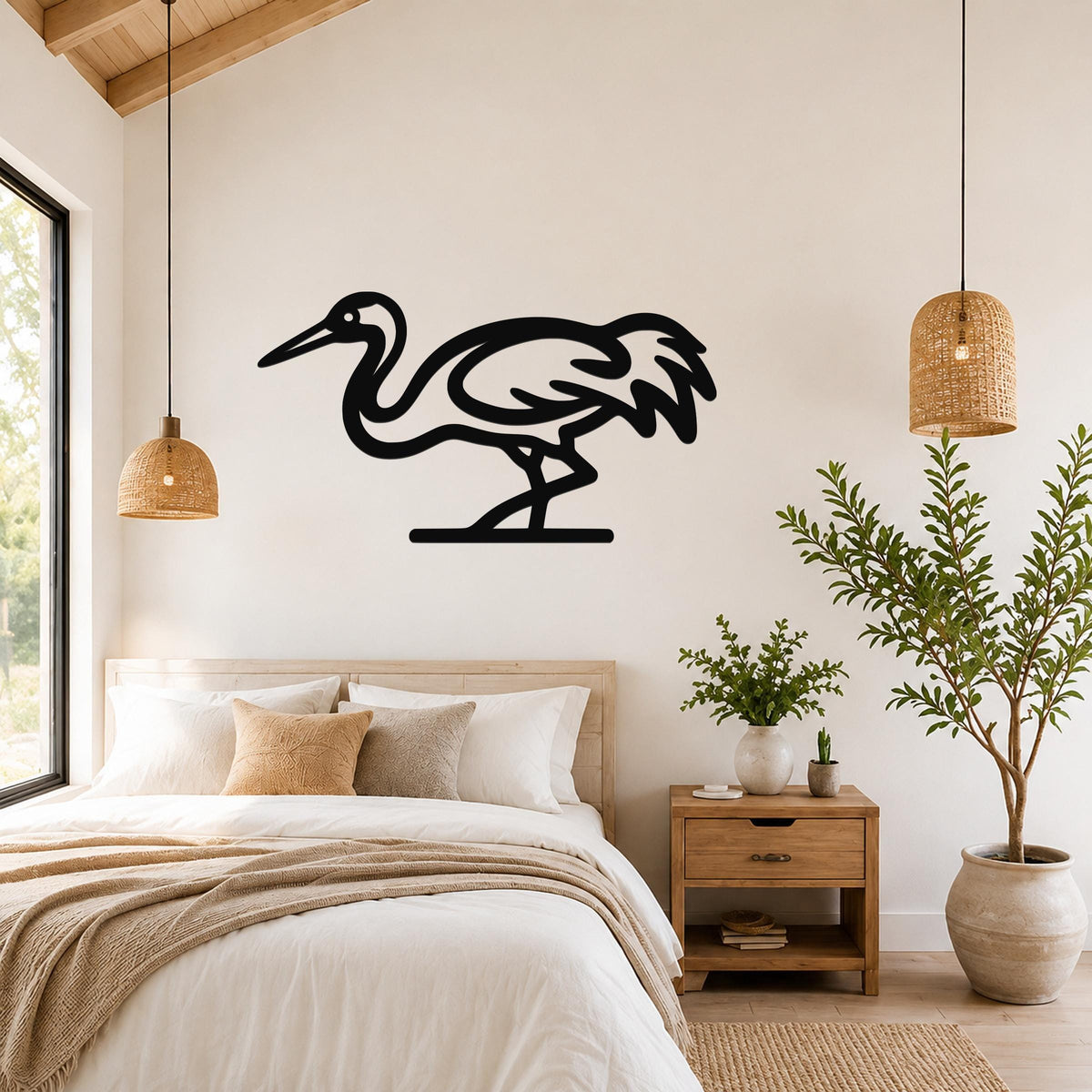 Black metal crane wall art in a minimalist silhouette style, mounted on a bedroom wall above a bed.