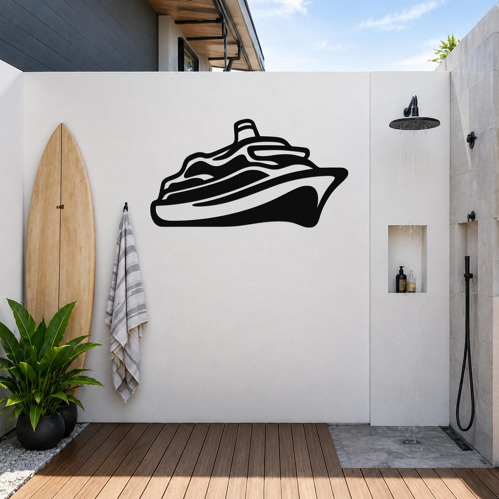 Black metal cruise ship wall art silhouette mounted on a white outdoor wall above a wooden deck, next to a surfboard and shower area.