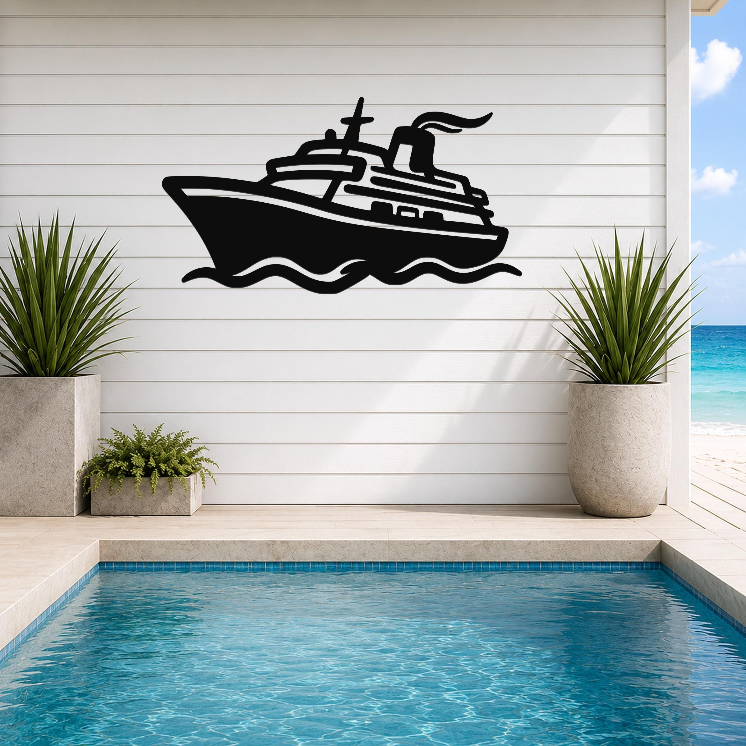 Black metal wall art cutout of a cruise ship with wave lines, mounted on a white shiplap wall above a pool with potted plants.