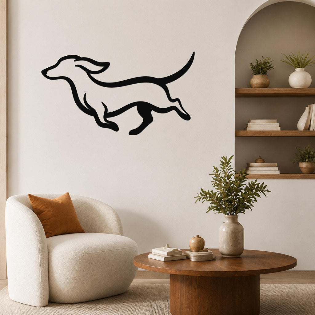Black metal dachshund wall art with bold silhouette lines, mounted on a living room wall above a white armchair.