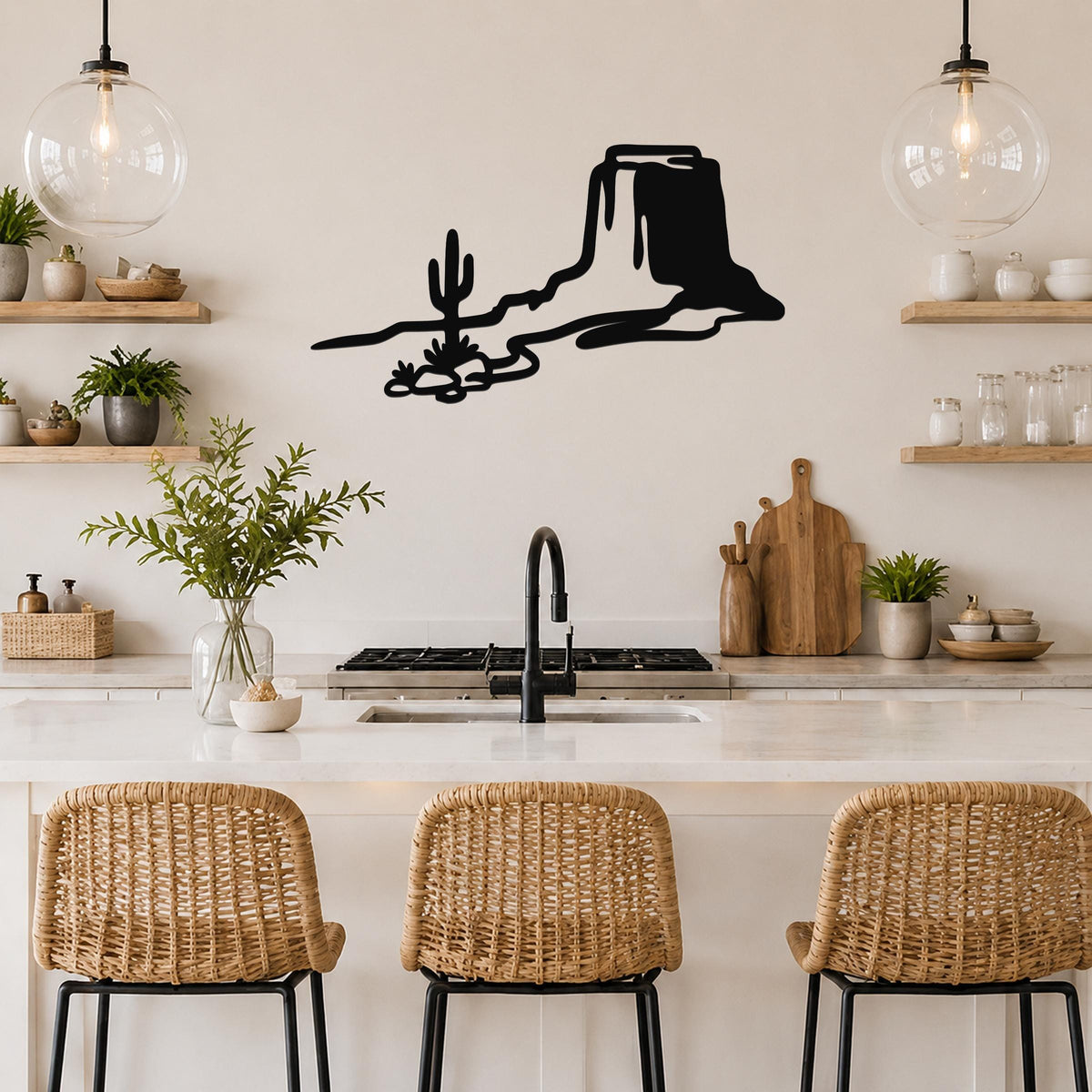 Black metal wall art with a desert mesa and cactus silhouette, mounted above a kitchen counter.