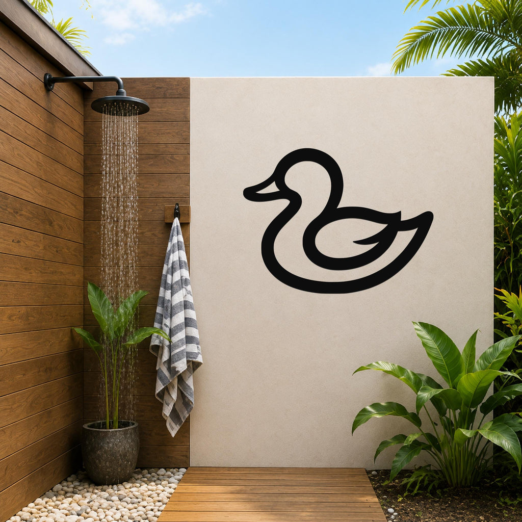 Black metal duck wall art silhouette mounted on a beige outdoor wall beside a wooden shower area with a running showerhead and tropical plants.