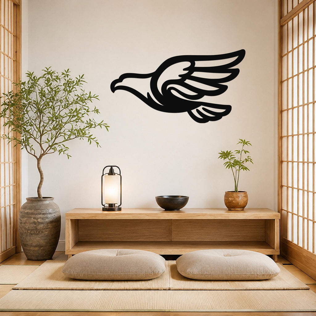 Black metal eagle wall art with a bold silhouette and extended wings, mounted on a light-colored wall above a wooden console in a minimalist room.
