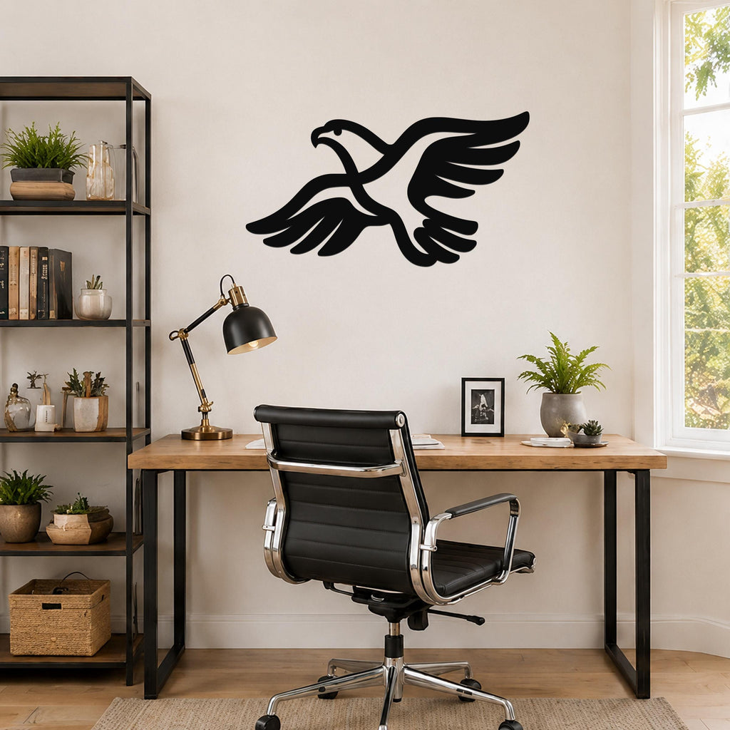 Black metal eagle wall art with outstretched wings and detailed feather cutouts, mounted on a wall above a wooden desk in a home office.