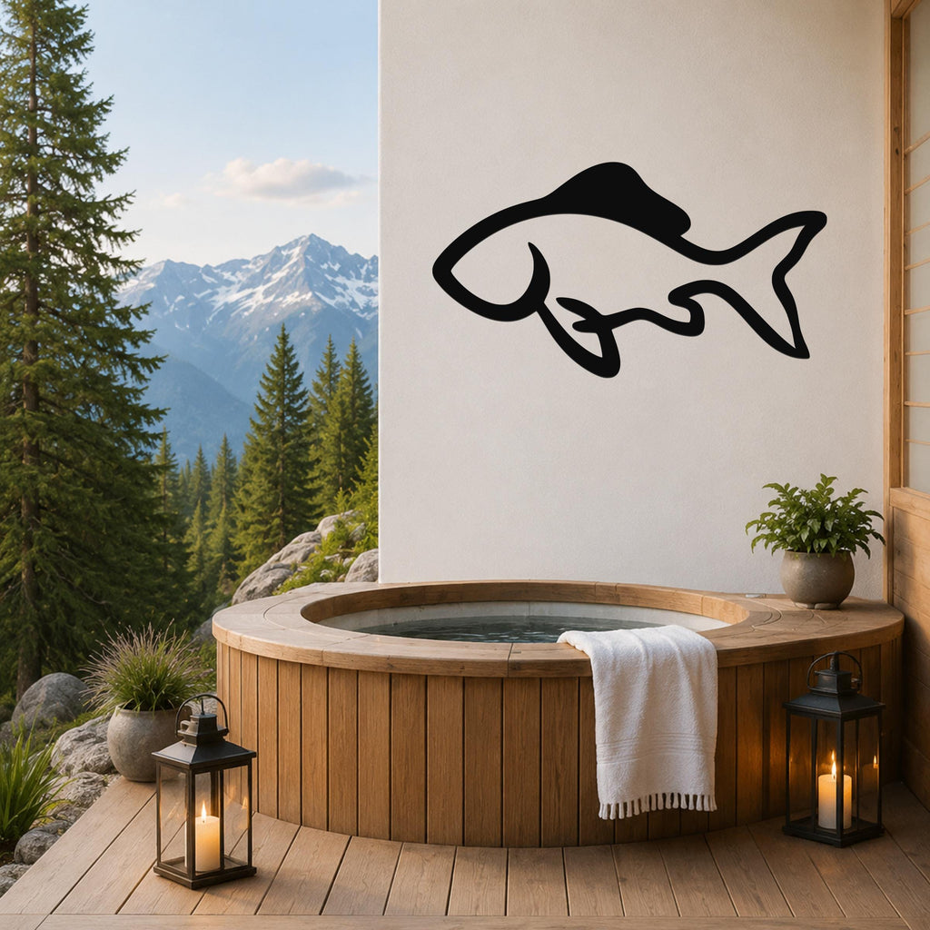 Black metal fish wall art with a graceful silhouette design, mounted on a white wall above a wooden hot tub on a mountain-view deck.