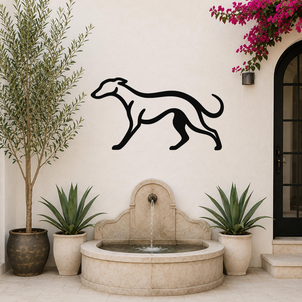 Black metal greyhound wall art silhouette mounted on a white outdoor wall above a stone fountain, flanked by potted plants and a flowering vine.
