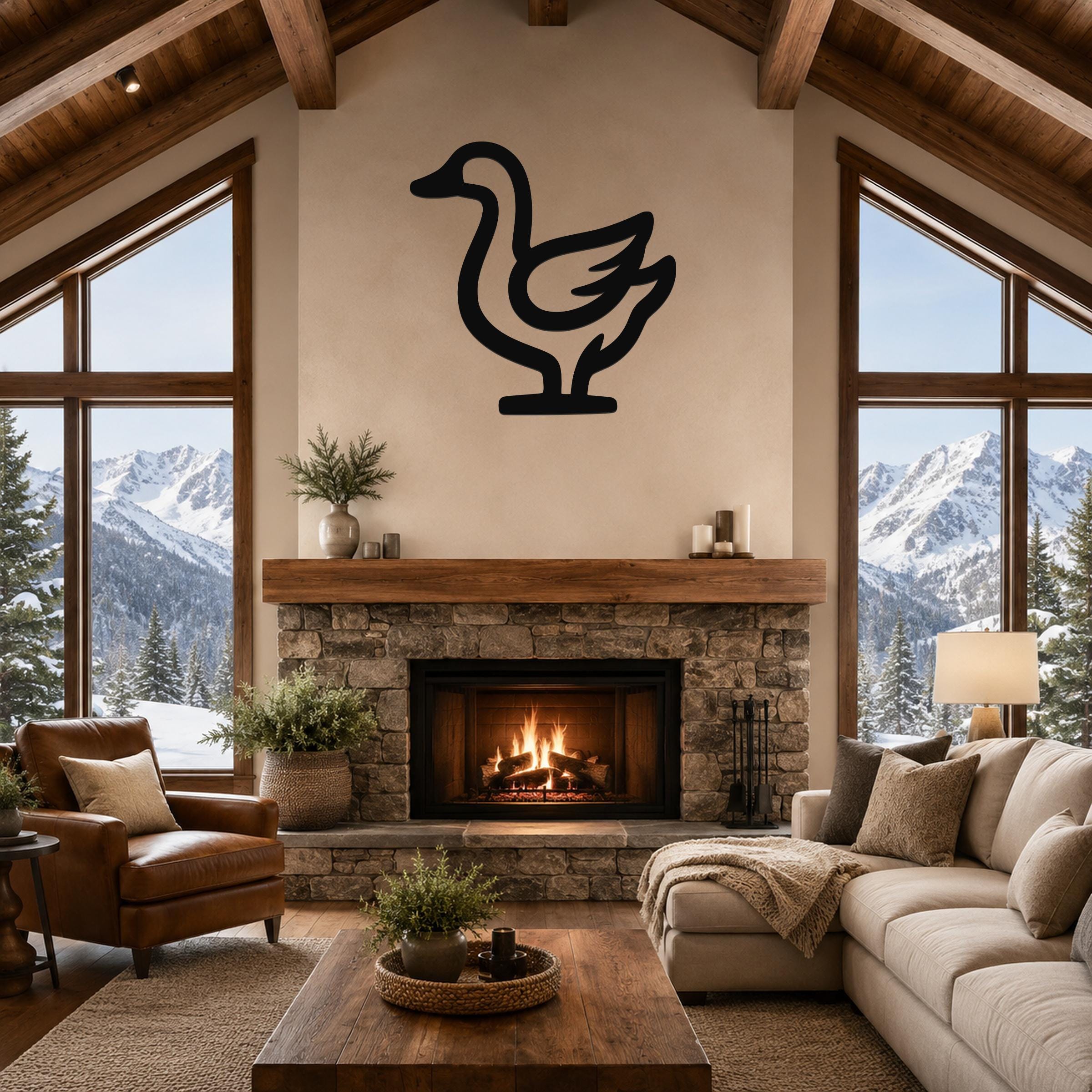 Black metal goose wall art silhouette mounted above a stone fireplace in a rustic living room with mountain views.