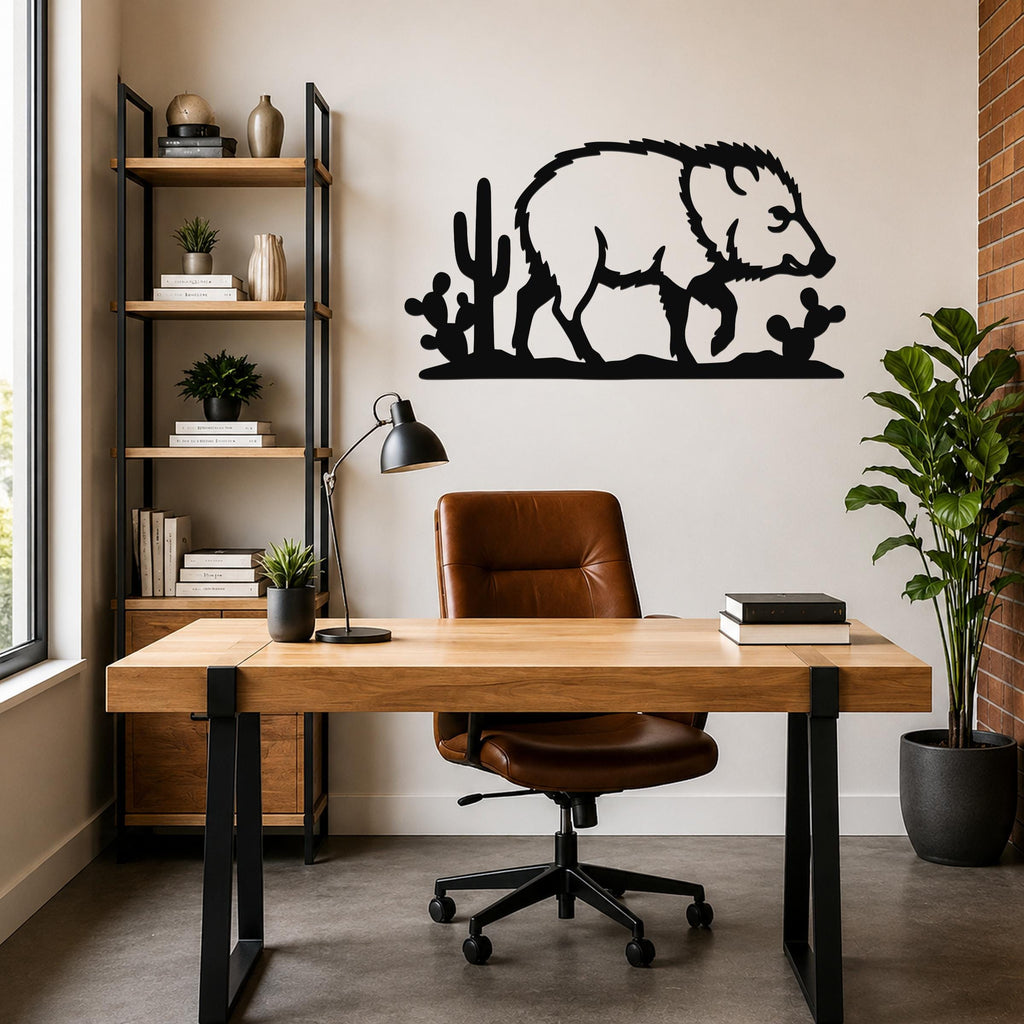 Black metal javelina wall art with cactus cutouts, mounted above a wooden desk in a modern home office.
