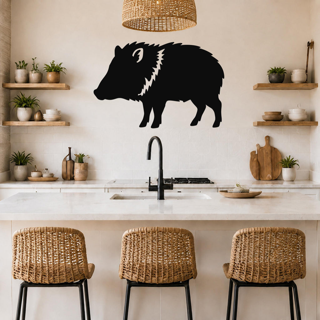 Black metal javelina wall art silhouette with white cutout details, mounted on a kitchen wall above a counter.