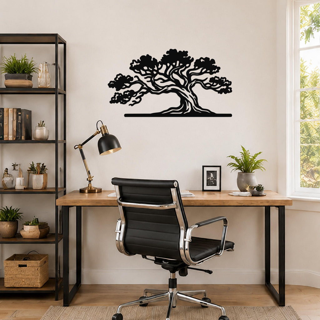 Black metal juniper tree wall art with intricate branch cutouts, mounted above a wooden desk in a home office.