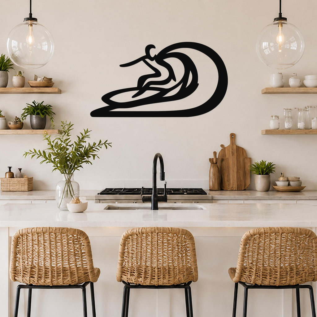 Black metal surfer wall sculpture with wave cutout, mounted above a kitchen counter in a coastal-style kitchen.