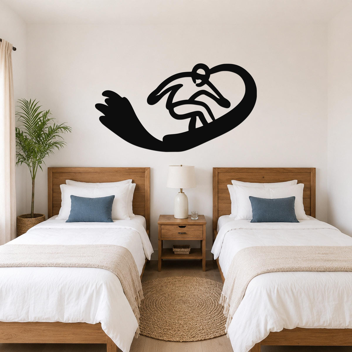 Black metal wall art silhouette of a snowboarder in motion, mounted above two twin beds in a bedroom.