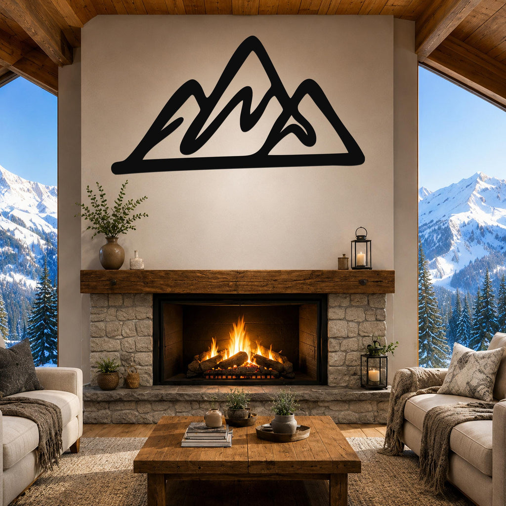 Black metal mountain silhouette wall art mounted above a stone fireplace in a rustic living room with large windows showing snowy peaks.