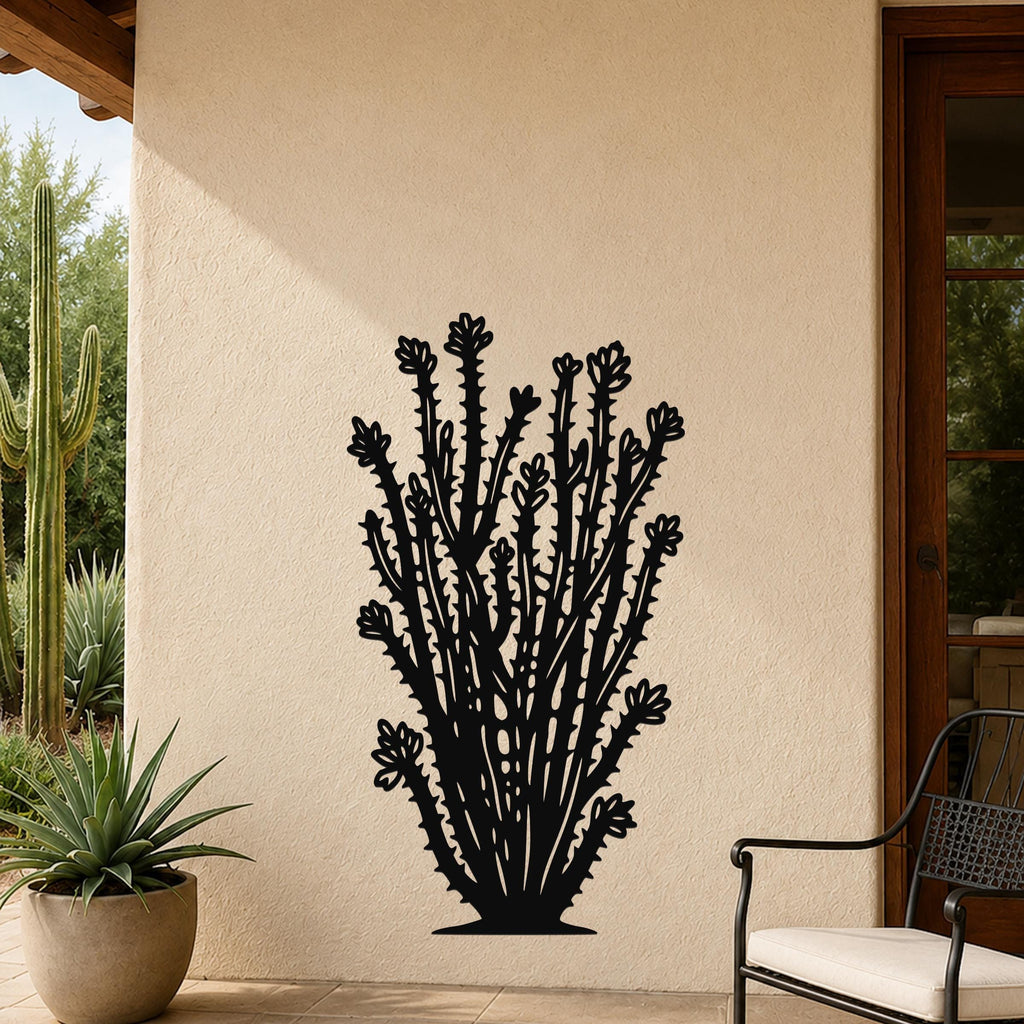 Black metal ocotillo wall art with detailed branch and flower cutouts, mounted on an outdoor patio wall beside a potted plant and chair.