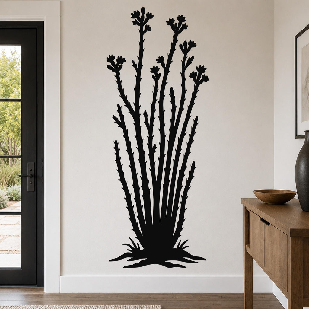 Black metal ocotillo wall art with flower and branch cutouts, mounted on a white wall in a living room near a door and console table.