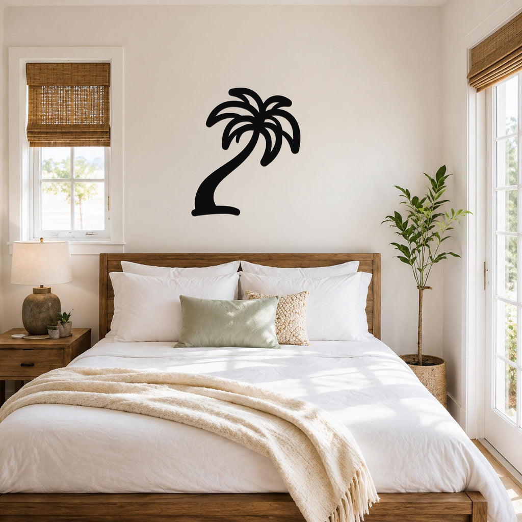 Black metal palm tree wall art with a silhouette design, mounted on a wall above a bed in a bright bedroom.
