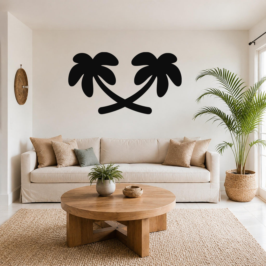 Black metal palm tree wall art with two silhouetted trees, mounted above a beige sofa in a living room.