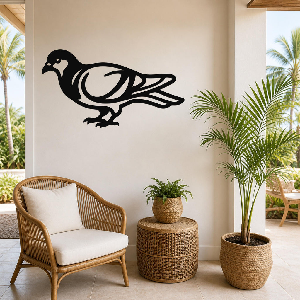 Black metal pigeon wall art with internal cutout details, mounted on a light-colored wall above a wicker chair in a patio setting.