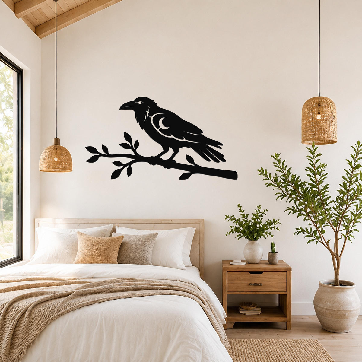 Black metal raven wall art silhouette perched on a branch, mounted above a bed in a bright bedroom.