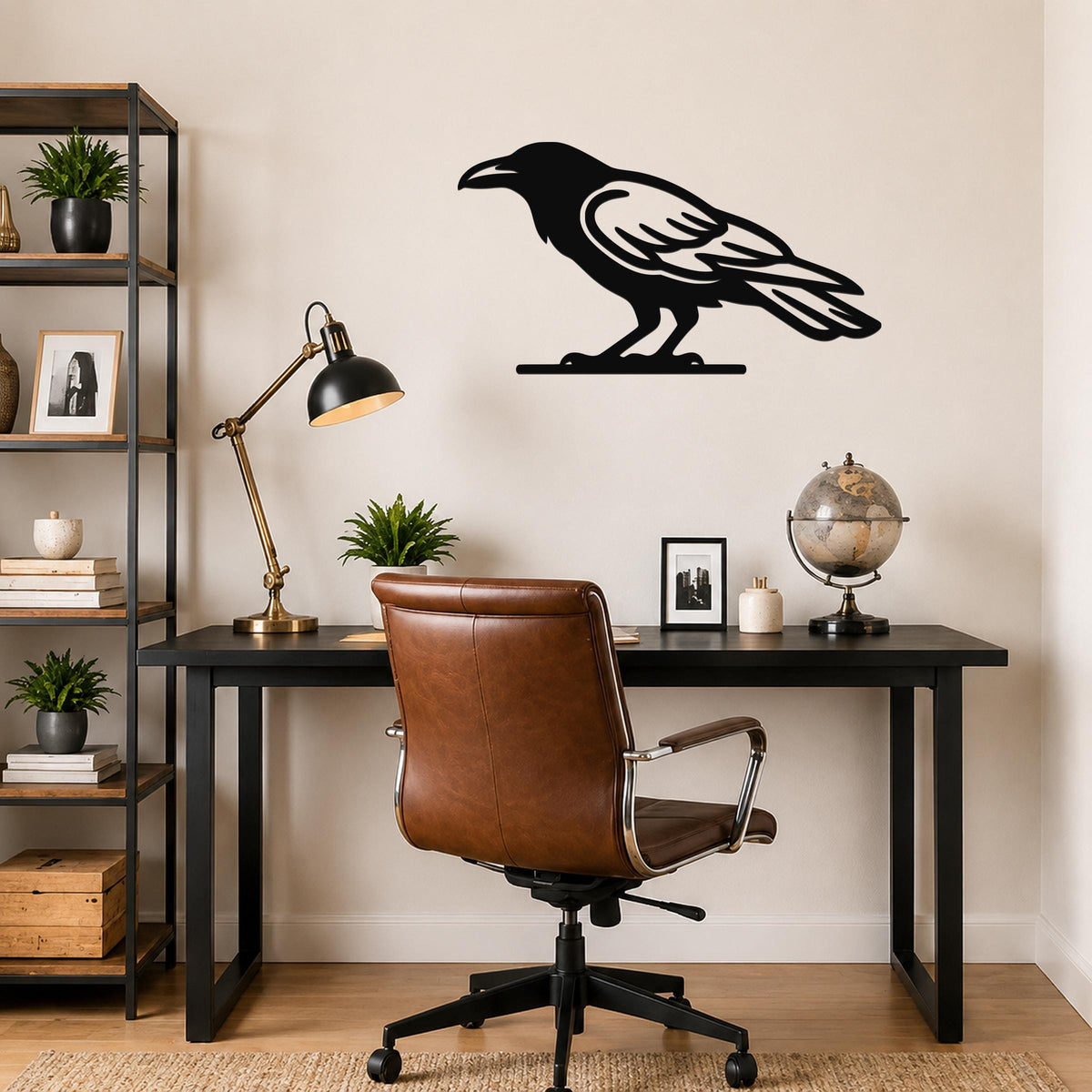 Black metal raven wall art silhouette with detailed feather cutouts, mounted on a wall above a black desk in a home office.