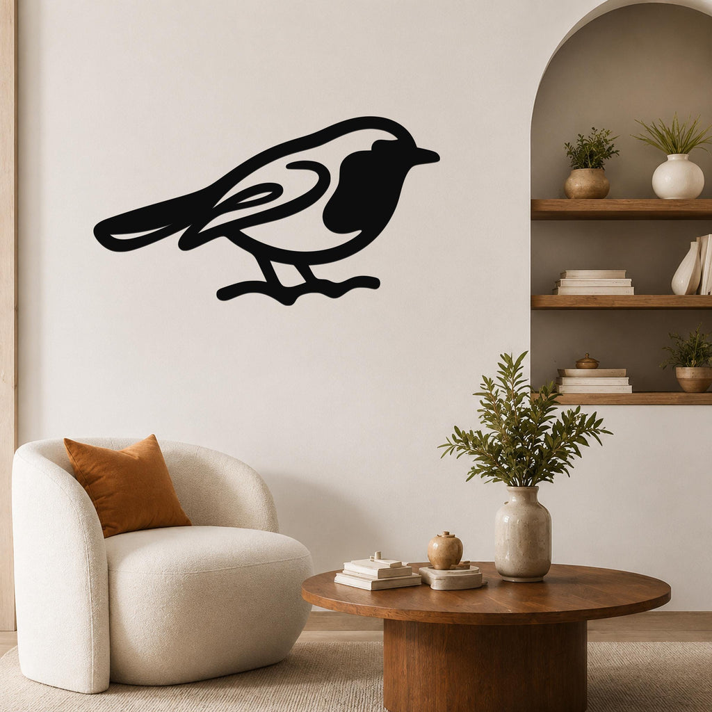 Black metal robin wall art silhouette with internal cutout details, mounted on a living room wall above a round wooden coffee table.