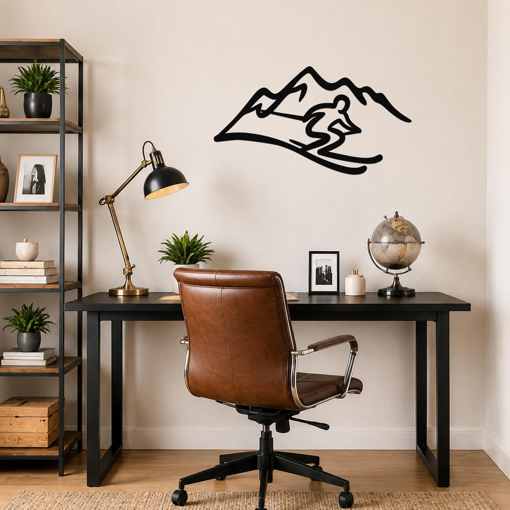 Black metal skier and mountain wall art with dynamic silhouette cutouts, mounted above a black desk in a home office.
