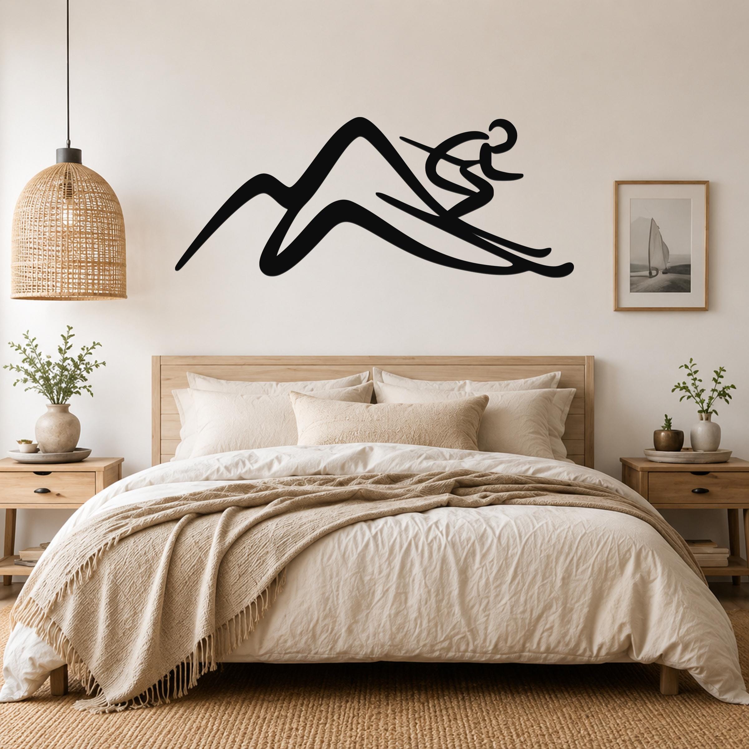Black metal wall art featuring a skier silhouette above a bed in a neutral bedroom.