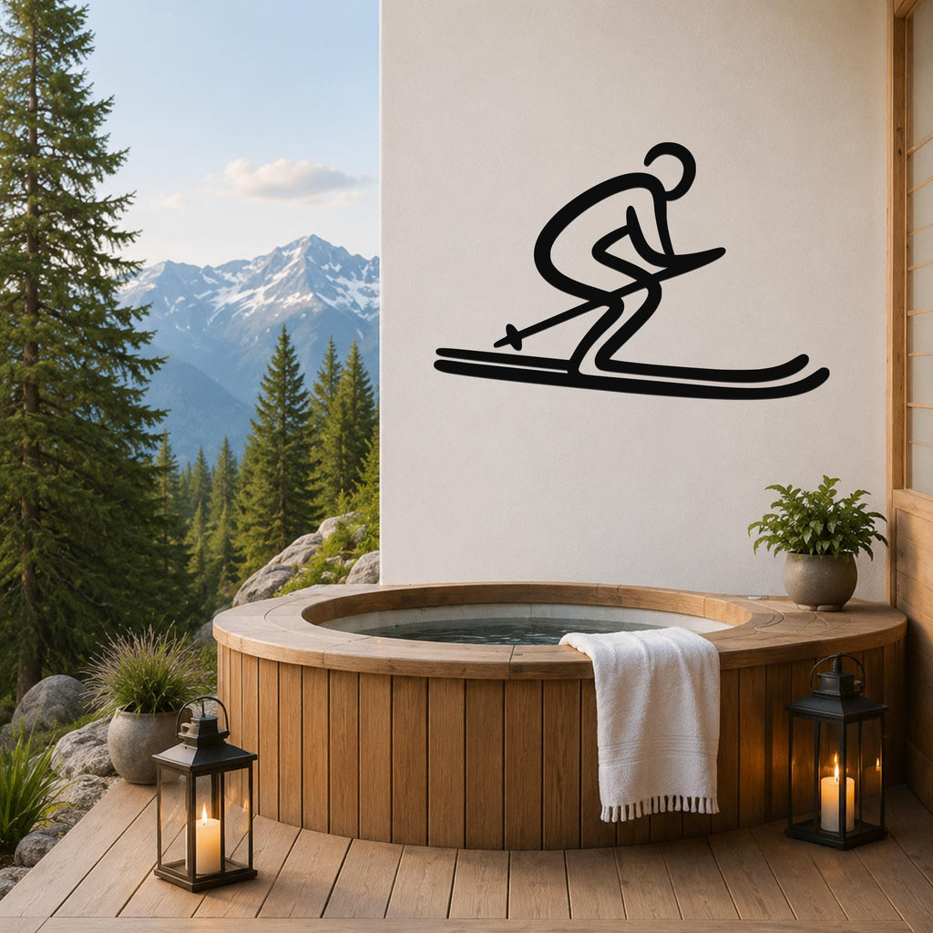 Black metal wall art of a dynamic skier silhouette, mounted on a white wall above a wooden hot tub on a mountain-view deck.