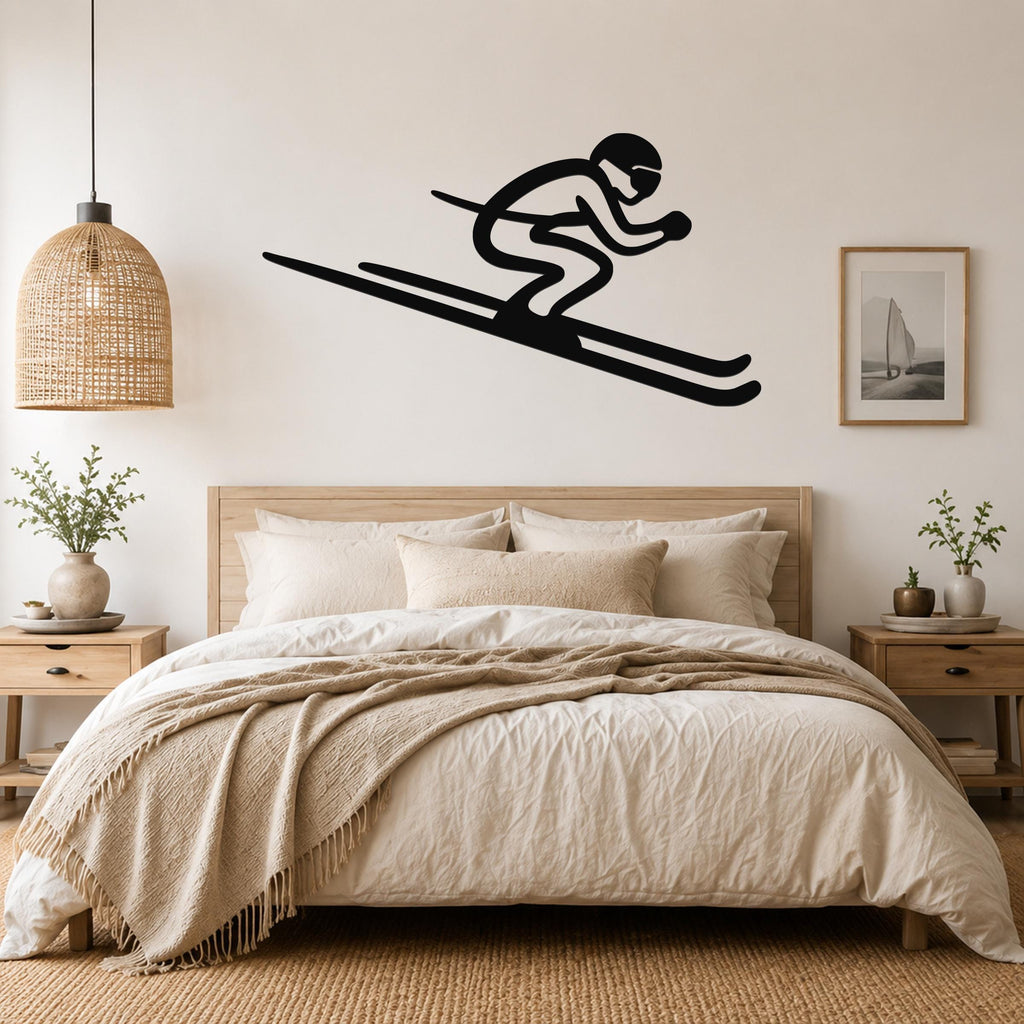 Black metal skier silhouette wall art with motion lines, mounted above a bed in a neutral bedroom.