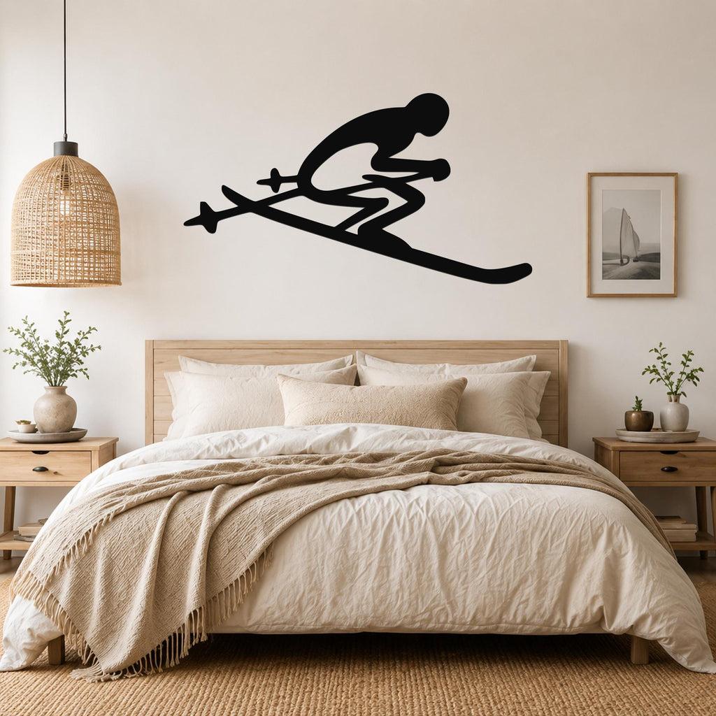 Black metal wall art of a skier silhouette with ski poles, mounted above a bed in a bedroom.