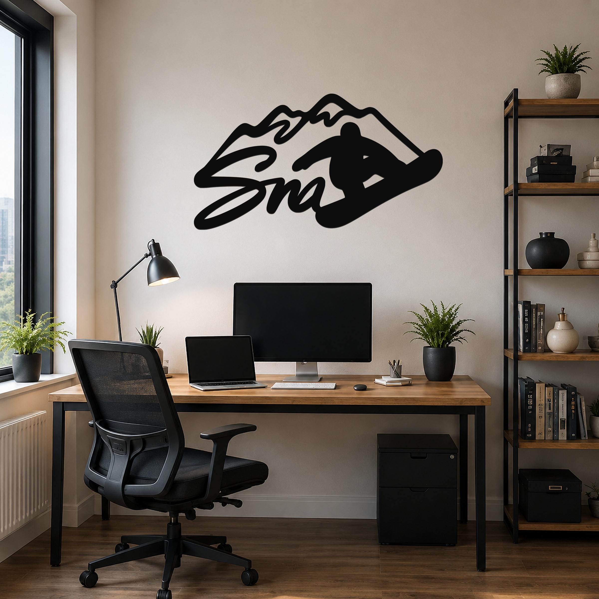 Black metal wall art featuring a snowboarder silhouette and mountain design, mounted above a wooden desk in a home office.