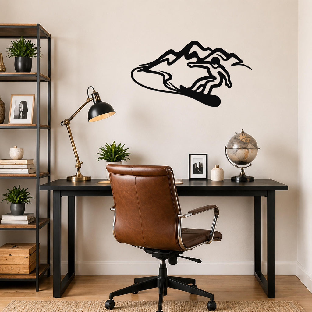 Black metal wall art silhouette of a snowboarder in motion above a desk, mounted on a light-colored wall in a home office.