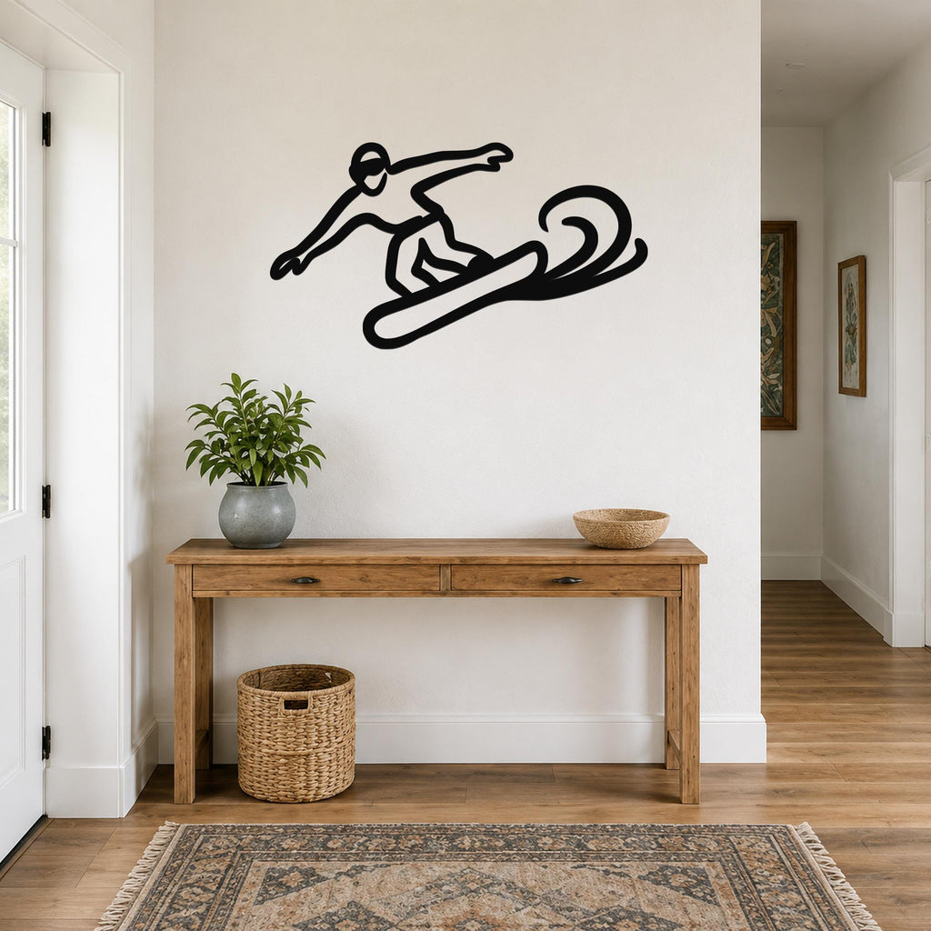 Black metal snowboarder wall art with motion-line cutouts, mounted above a wooden console table in a hallway.