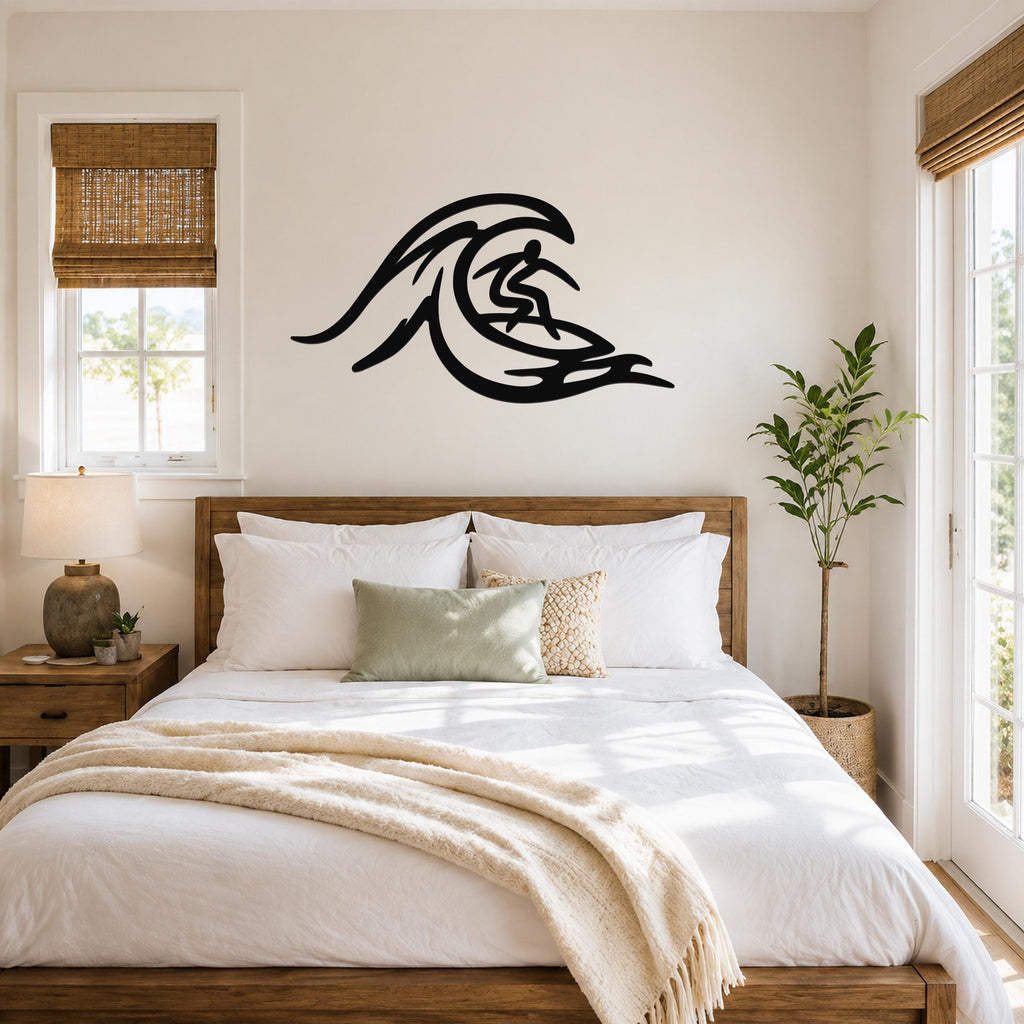 Black metal surfer wall art with wave cutout design, mounted above a wooden bed in a bright bedroom.