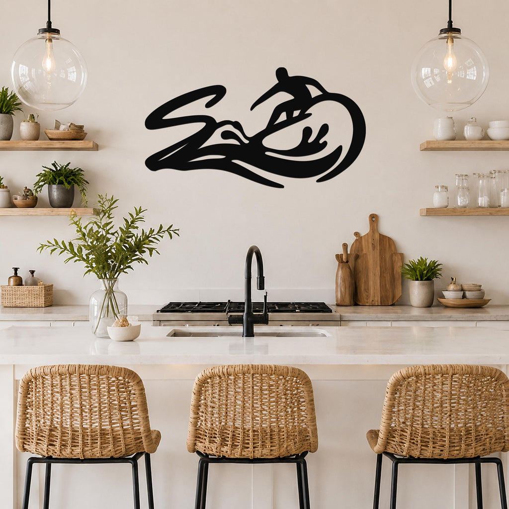 Black metal surfer wall art with wave and rider silhouette, mounted above a kitchen counter in a coastal-style kitchen.