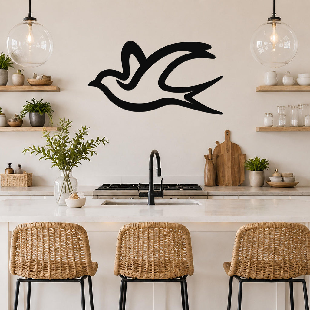 Black metal swallow bird wall art with flowing silhouette lines, mounted on a kitchen wall above a counter with wicker stools.