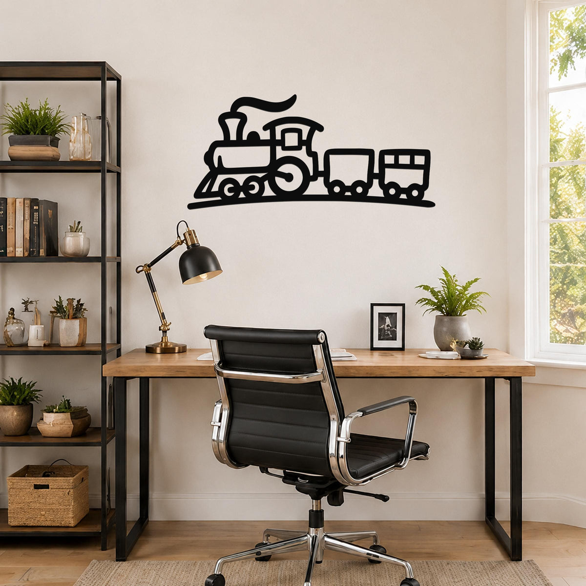 Black metal train wall art silhouette with smoke and wheels, mounted above a wooden desk in a home office.