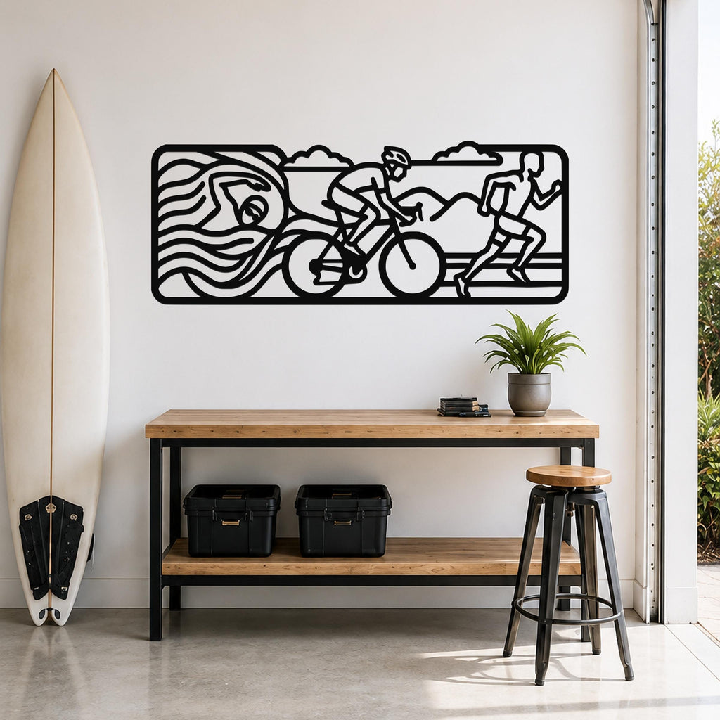 Black metal triathlon wall art with swim, bike, and run silhouettes, mounted above a wooden console table in a bright entryway.