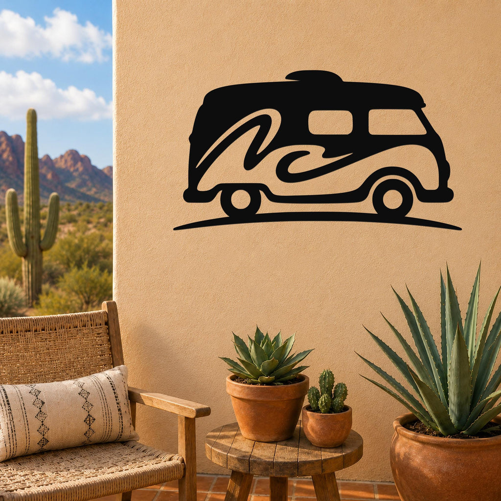 Black metal RV wall art with wave cutout design, mounted on a beige outdoor wall above a small wooden table with potted succulents.