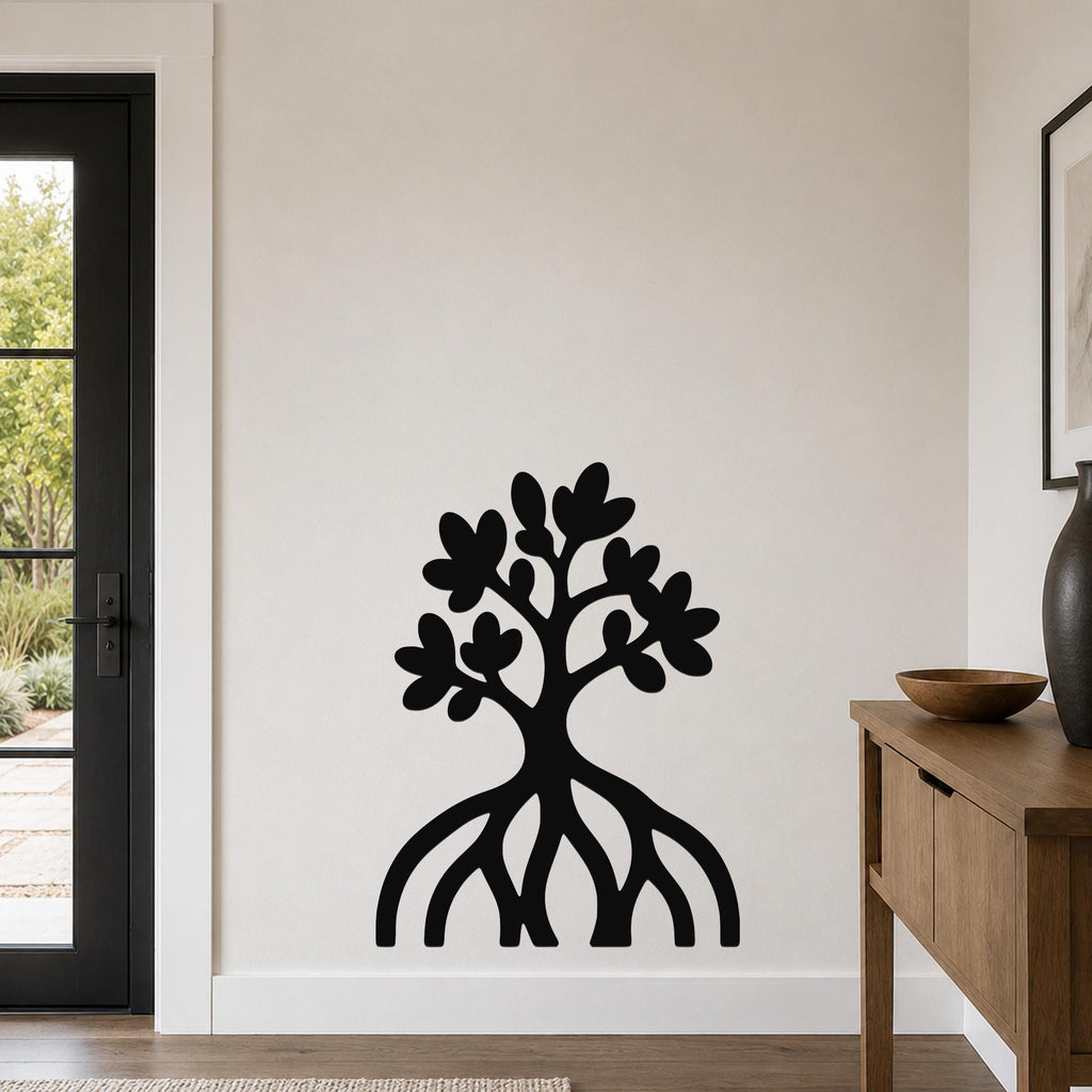 Black metal wall art cutout of a mangrove tree with visible roots and leafy canopy, mounted on a light-colored wall in a modern entryway.