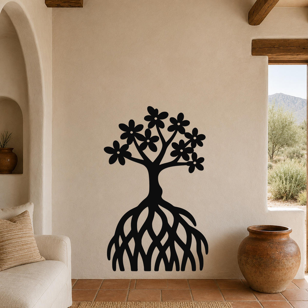 Black metal wall art of a tree with flower-shaped leaves and exposed roots, mounted on a beige wall in a living room with terracotta flooring and wooden beams.