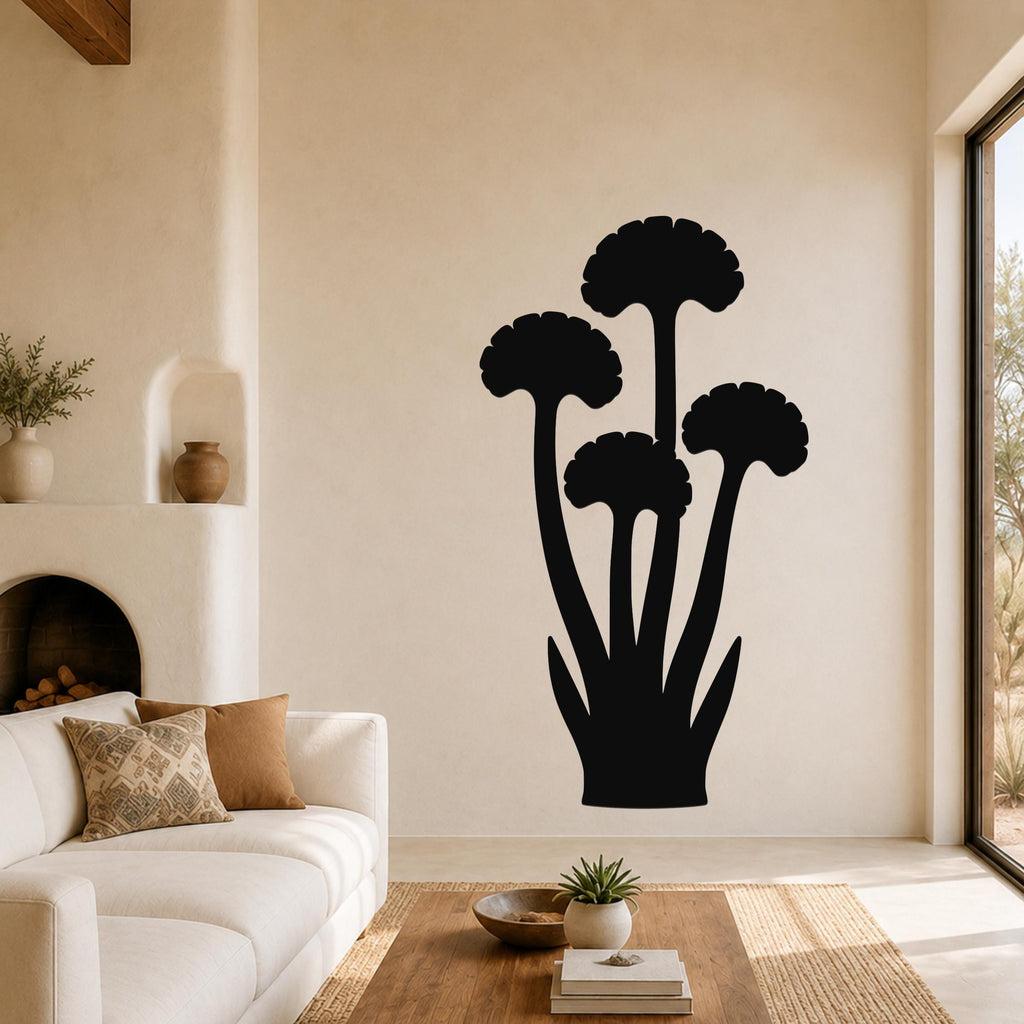 Black metal ginkgo leaf wall art with a silhouette design, mounted on a living room wall above a sofa.